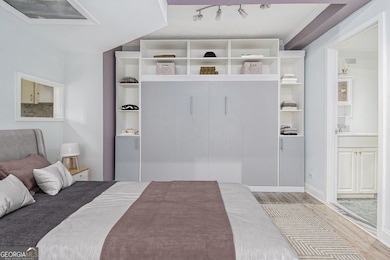 Step inside to a Bright, Open Living Space with Floor-to-Ceiling Windows, Hardwood Floors, and Classic Crown Molding throughout