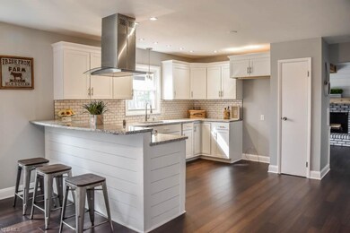 Remodeled kitchen with new white cabinets and a br