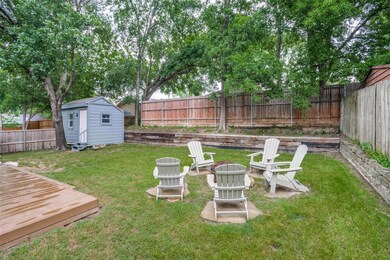 View of yard with a wooden deck and a storage shed