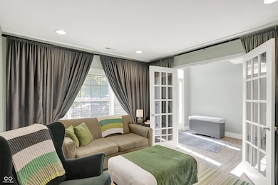 living area featuring french doors, wood finished floors, and recessed lighting