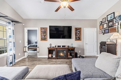 Living room featuring ceiling fan and wood finished floors