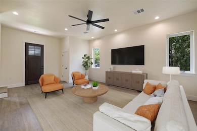 Living room with visible vents, recessed lighting