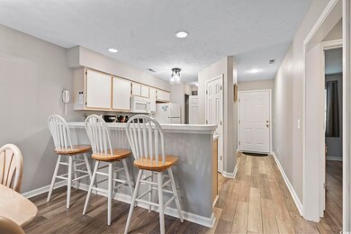 Kitchen featuring a kitchen bar, kitchen peninsula