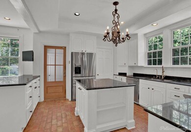 Kitchen featuring a kitchen island, appliances wit