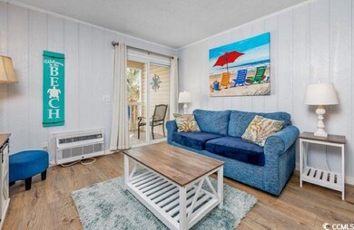 Living area featuring wood finished floors, a wall unit AC, and wood walls
