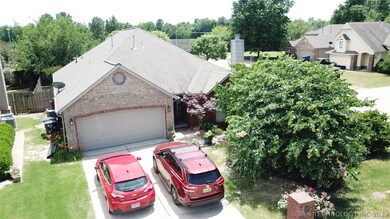 Two car garage and driveway on a corner lot.  Hous