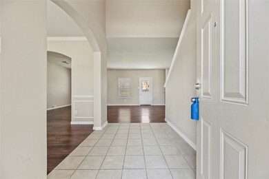 Tiled front entry with neutral colors and high cei