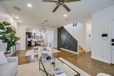 Living area featuring visible vents, concrete flo
