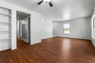 Unfurnished room featuring dark wood-style floori