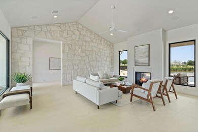 Living room with a multi sided fireplace, a ceili