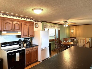 Kitchen featuring electric range, white refrigerat