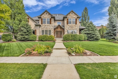 Craftsman house with a front lawn and stone siding