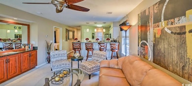Living room featuring light carpet and ceiling fan
