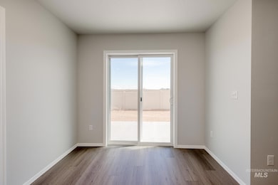 Unfurnished room featuring wood finished floors and baseboards
