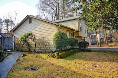 View of side of property featuring a yard