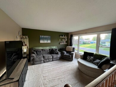 Carpeted living room featuring a textured ceiling