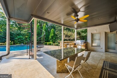 Covered terrace with kitchen area and tv