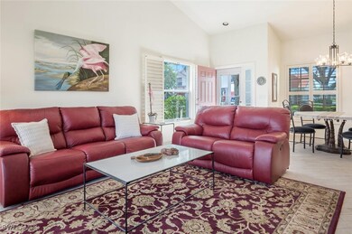Living room with high vaulted ceiling and an invit