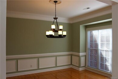 Formal dining room with crown, chair and picture f