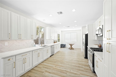 Kitchen featuring stainless steel appliances, ligh