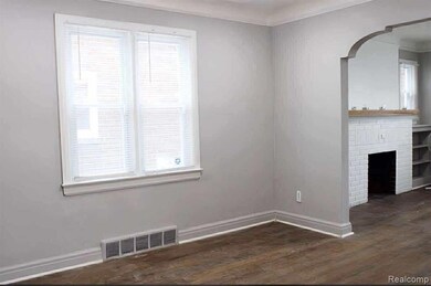 Unfurnished living room featuring dark wood-style flooring, a brick fireplace, crown molding, and arched walkways