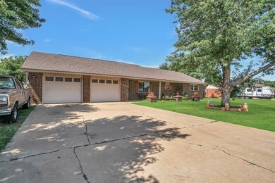 Ranch-style house featuring brick siding, a front yard, a garage, and concrete driveway