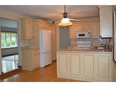 This large updated kitchen offers blonde cabinetry