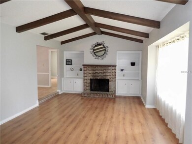 Formal living room with beamed ceiling