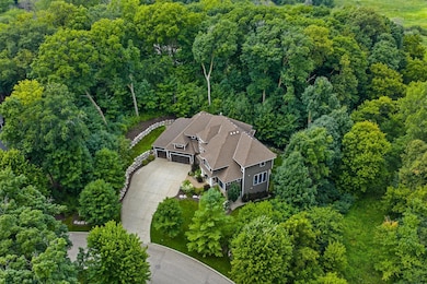 Aerial view of this stunning wooded lot with private fenced backyard! Located on a quite cul-de-sac
