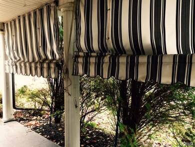 Private Side Porch With Slate Flooring And Awnings