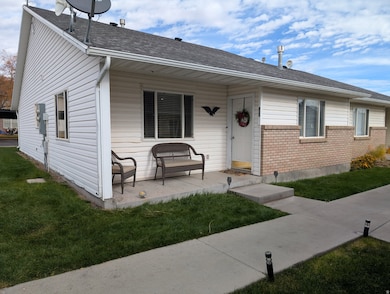 Bungalow-style home with brick siding, a front yard, and roof with shingles