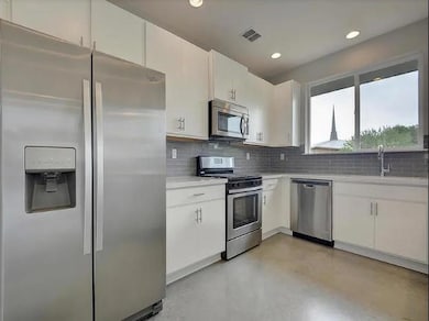 Kitchen featuring stainless steel appliances, fin