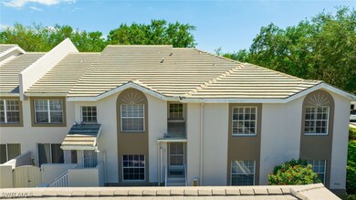 Rear view of house featuring fence, stucco siding,