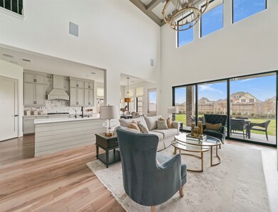 This light and bright spacious living room is the perfect layout for entertaining or just relaxing! Whether it's simply a night in or entertaining family and friends, this home has ample open space for everyone to enjoy! Featuring a wall of windows, soaring high ceilings, recessed lighting with wonderful access to your gorgeous kitchen! (This is not the actual home but a completed model of this home, fixtures and colors may vary)
