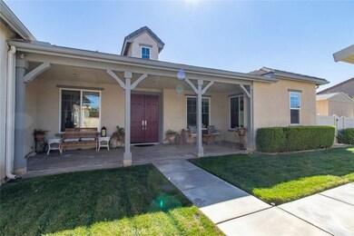Covered front porch. Home has rain gutters. Note: there's a shed behind the gate.