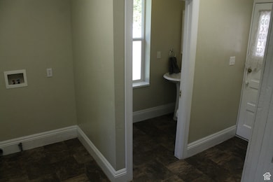 Laundry area with half bath, connected to back walled in and covered patio.