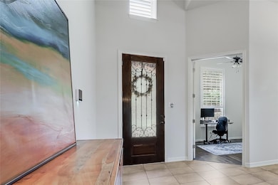 Foyer entrance with light tile patterned flooring