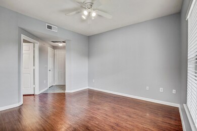 Spare room featuring a ceiling fan, dark wood-sty
