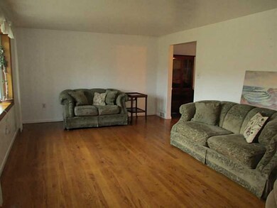 Living Room. Hardwood floors throughout!  This bri