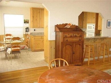 View from living room with wood floors to the dini