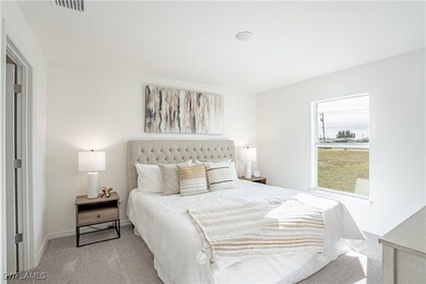 Carpeted bedroom with baseboards and visible vents