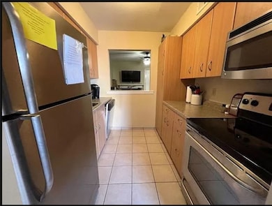 Kitchen with light countertops, light tile pattern