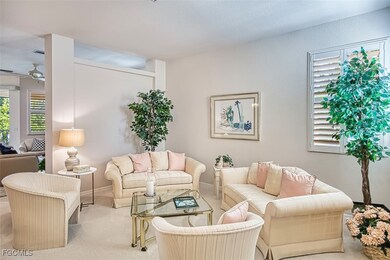 Living area with carpet and a ceiling fan