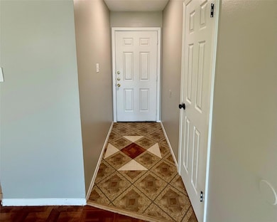 Doorway to outside featuring baseboards