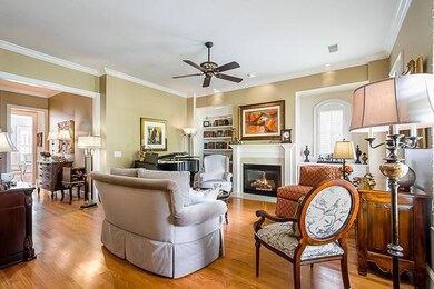 Enjoy the Good Life:  The gas fireplace shares the Family Room with built-ins and hardwood floors.   The entire townhouse is meticulous and tastefully decorated, including the classic wall coverings. 