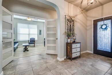 Entrance foyer featuring arched walkways, light ti