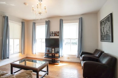 Living room featuring a chandelier and hardwood /