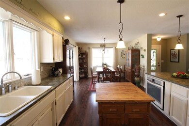 Gourmet Kitchen with Corrian counters, new appliances, wood floors, new lighting open to dining and liv rm