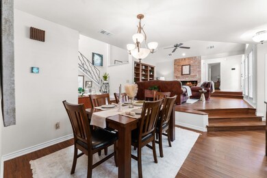 Dining area featuring a brick fireplace, vaulted 