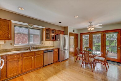 Updated eat-in kitchen with granite counter tops, stainless steel appliances, pantry, work desk and atrium door to patio.